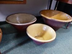 THREE LARGE POTTERY PROVING BOWLS AND A LIDDED FLOUR JAR.