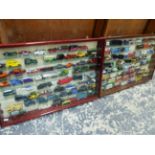 TWO GLAZED WALL DISPLAY CABINETS CONTAINING DIE CAST VEHICLES.