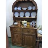 A CARVED OAK SMALL DRESSER, TWO SHELF UPPER SECTION ABOVE DRAWERS AND CUPBOARDS H 179 x W 95 x D