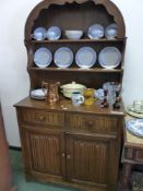 A CARVED OAK SMALL DRESSER, TWO SHELF UPPER SECTION ABOVE DRAWERS AND CUPBOARDS H 179 x W 95 x D