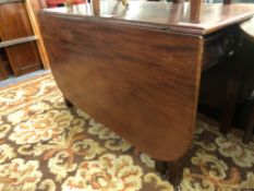 A LARGE ANTIQUE MAHOGANY DROP LEAF DINING TABLE WITH TWO APRON DRAWERS. H 73 W 114 D 58cms CLOSED