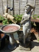 A BIRDBATH AND A LARGE GARDEN STATUE