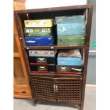 A CHINESE HARDWOOD CABINET OF TWO OPEN SHELVES OVER TWO TRELLISED CUPBOARD DOORS AND BRACKET FEET. W