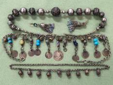 A VINTAGE TRIBAL NECKLACE SET WITH FILIGREE WORKED SPHERES, TOGETHER WITH A SMALLER EXAMPLE AND