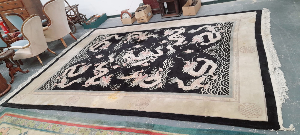 A CHINESE DRAGON DESIGN CARPET. 380 x 277cms