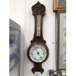 AN OAK CASED ANEROID BAROMETER AND MERCURY THERMOMETER.