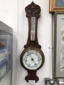 AN OAK CASED ANEROID BAROMETER AND MERCURY THERMOMETER.