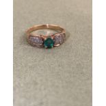 A EMERALD DIAMOND UNHALLMARKED RING ASSESSED AND STAMPED 14ct. SIZE M WEIGHT 2.2grms