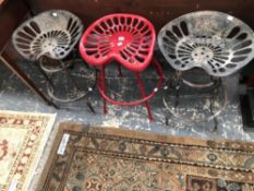 THREE UNUSUAL TRACTOR SEAT SWIVEL STOOLS