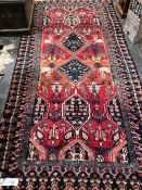 A PERSIAN TRIBAL RUG 308 x 132 cms