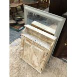 A RUSTIC PAINTED PINE HANGING CABINET TOGETHER WITH A PAINTED CONVEX MIRROR AND ANOTHER MIRROR OF