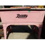 A BEATTY PINK PAINTED LAUNDRY CABINET.