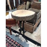 A CAST IRON BASE RUSTIC TABLE
