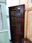 A BESPOKE OAK CORNER CUPBOARD WITH A GLAZED DOOR TO THE UPPER HALF AND A PANELLED ONE BELOW. W 80