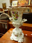 A 19th C. PARIS PORCELAIN TWO HANDLED URN PAINTED WITH FLORAL PANELS. H 35cms.