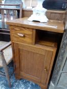 A 20th C. OAK BEDSIDE CUPBOARD TOGETHER WITH AN ARTS AND CRAFTS ELBOW CHAIR WITH A RUSH SEAT