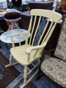 A YELLOW PAINTED ROCKING ARMCHAIR