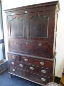 AN EARLY 19th CENTURY OAK COUNTRY MADE TWO PART PRESS CABINET, PANEL DOORS ABOVE DROP SECTION SIX