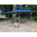 A VERY LARGE BLUE COLONIAL SHADE GARDEN PARASOL 3.75M X 3.0M