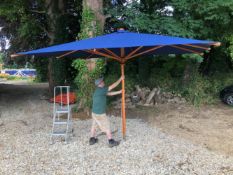 A VERY LARGE BLUE COLONIAL SHADE GARDEN PARASOL 3.75M X 3.0M