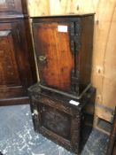 AN EARLY OAK SPICE CABINET TOGETHER WITH A CARVED EXAMPLE