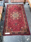 A MACHINE MADE RUG OF PERSIAN DESIGN 183 x 93 cms