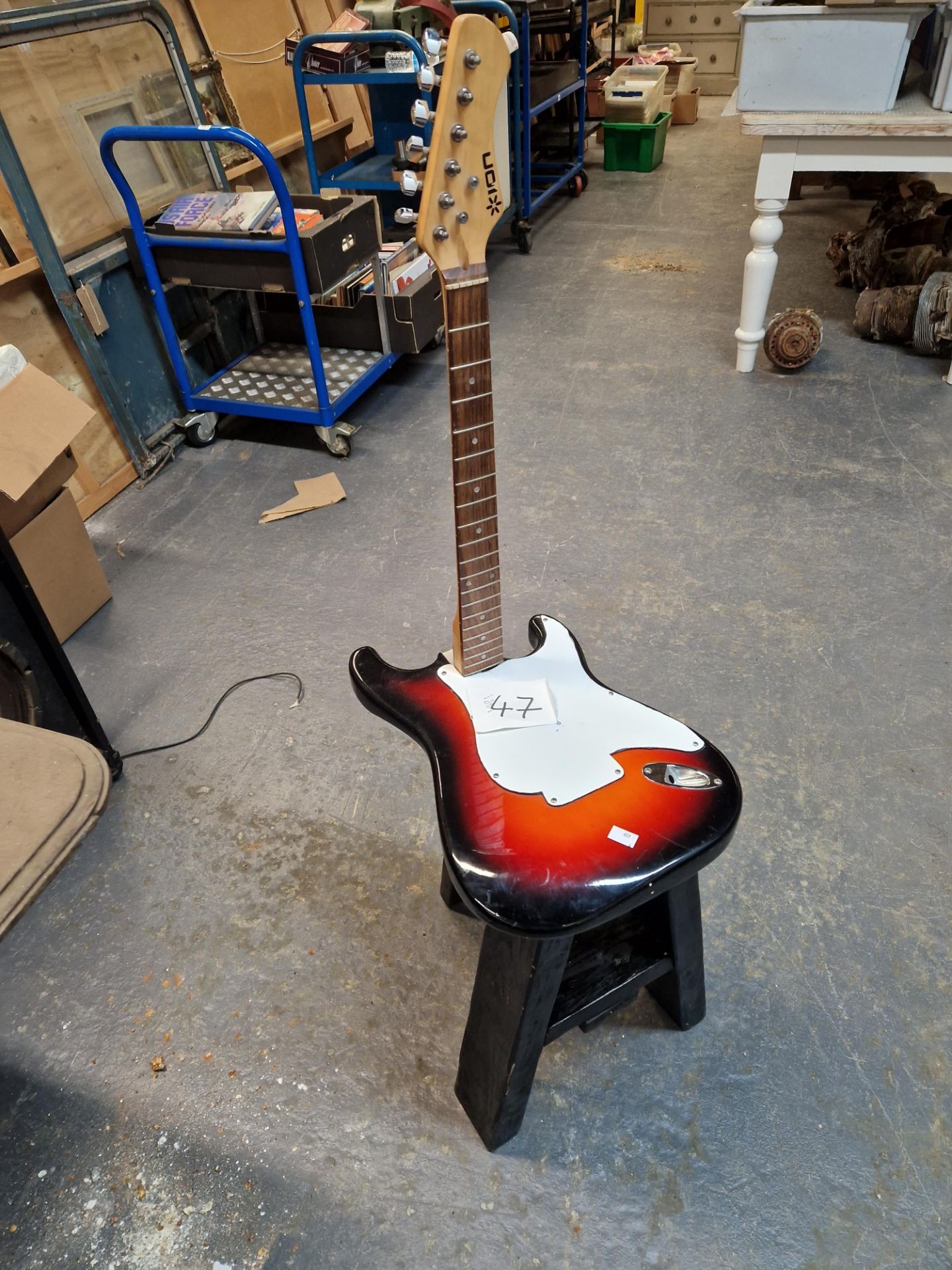AN UNUSUAL BACK STOOL, CONVERTED FROM AN ELECTRIC GUITAR.