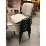 A SET OF SIX STACKING CHAIRS.