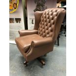 A BROWN LEATHER BUTTON BACK SWIVEL ARM CHAIR AND A RED LEATHER EXAMPLE SIMILAR.