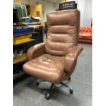 A BROWN LEATHER LARGE OFFICE DIRECTORS CHAIR