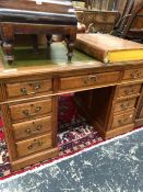 A 20th C. OAK PEDESTAL DESK, THE GREEN LEATHER INSET TOP OVER A KNEEHOLE DRAWER FLANKED BY BANKS