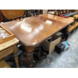 A VICTORIAN MAHOGANY DINING TABLE WITH TWO LEAVES, THE ENDS WITH CANTED CORNERS ABOVE FLUTED