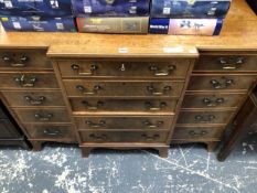 A 20th C. MAHOGANY BREAKFRONT SIDE BOARD, THE CENTRAL CUTLERY DRAWER OVER FOUR OTHER DRAWERS FLANKED