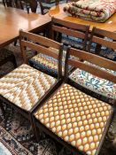 A SET OF SIX 1970S TEAK CHAIRS, EACH WITH TWO CURVED HORIZONTAL RAIL BACKS, NEEDLE WORKED SEATS