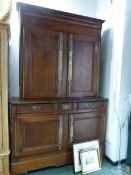 A 19th C. FRENCH OAK CABINET, THE DOORS OF THE UPPER HALF WITH FULL LENGTH BRASS FINGER PLATES,