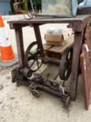 AN ANTIQUE WOOD WORKING LATHE ON INDUSTRIAL STAND