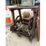 AN ANTIQUE WOOD WORKING LATHE ON INDUSTRIAL STAND