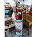 A LARGE ORIENTAL CYLINDER STICK STAND AND VARIOUS WALKING STICKS.