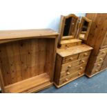 A MODERN PINE WARDROBE, CHEST OF DRAWERS, OPEN BOOKCASE AND A DRESSING TABLE MIRROR