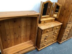 A MODERN PINE WARDROBE, CHEST OF DRAWERS, OPEN BOOKCASE AND A DRESSING TABLE MIRROR