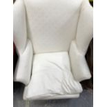 A MAHOGANY WING ARMCHAIR UPHOLSTERED IN WHITE WITH SQUARE SECTION FRONT LEGS