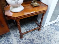 AN ARTS AND CRAFTS MAHOGANY TABLE, THE CANTED RECTANGULAR TOP ON SPIRAL TWIST LEGS JOINED BY