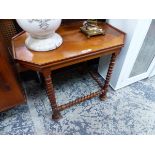 AN ARTS AND CRAFTS MAHOGANY TABLE, THE CANTED RECTANGULAR TOP ON SPIRAL TWIST LEGS JOINED BY