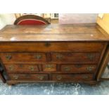 AN 18th C. OAK DRESSER WITH COFFER TOP OVER A CONFIGURATION OF SEVEN DRAWERS ABOVE BRACKET FEET. W