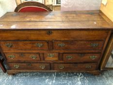 AN 18th C. OAK DRESSER WITH COFFER TOP OVER A CONFIGURATION OF SEVEN DRAWERS ABOVE BRACKET FEET. W