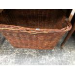 A BASKET WITH TWO IRON TRIANGULAR HANDLES, THE TOP. 80 x 58cms.
