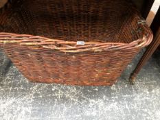 A BASKET WITH TWO IRON TRIANGULAR HANDLES, THE TOP. 80 x 58cms.