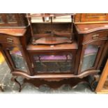 A LATE VICTORIAN MAHOGANY SIDE CABINET, THE CENTRAL SHELF RECESSED BELOW FLANKING DRAWERS WITH BLIND