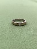 A TENSION SET DIAMOND SOLITAIRE RING, ASSESSED AS 12ct WHITE GOLD. WEIGHT 5.34grms.