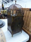 A LANTERN CLOCK WITH FRENCH PLATFORM ESCAPEMENT MOVEMENT STRIKING ON THE BELL ABOVE